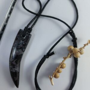 Merlinite tooth necklace on thong